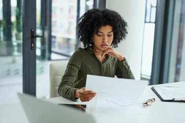 business woman looking at paperwork-GettyImages-1307841031 business woman looking at paperwork-GettyImages-1307841031