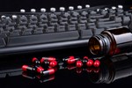 Roche, Inovio End Pact On Prostate Cancer Drug keyboard & pills 450x300