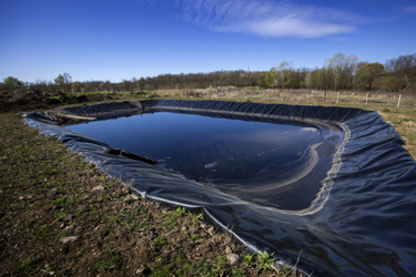 Insulated leachate pond with dirty water, part of landfill-GettyImages-1390782041