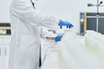 GettyImages-1196052154-scientist-in-lab-with-bottles