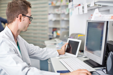 Pharmacist working at desk - GettyImages - 537315268