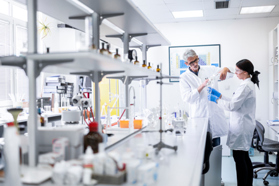 Biologics Manufacturing Innovation For Medicine Supply Security Scientists Mixing Solution In Lab GettyImages-1443286944
