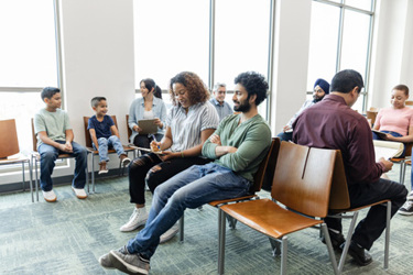 Large group of diverse people wait to see doctor-GettyImages-1745157941 Large group of diverse people wait to see doctor-GettyImages-1745157941