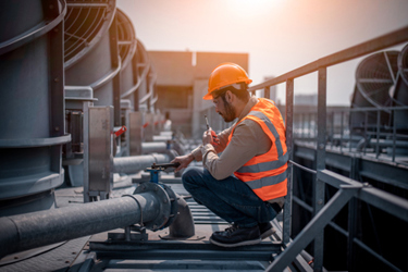 engineer checking cooling tower-GettyImages-1369464701