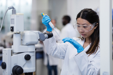 female scientist petri dish syringe-GettyImages-1646509066