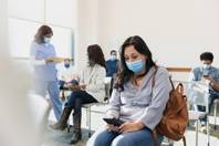 Adult woman sits in waiting room-GettyImages-1372189785