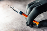 iStock-1283232421-syringe-glove-hand-injection