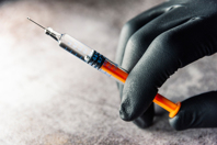 Nitrogen Purging Process Development For Oxygen Sensitive Formulations In Pre-Filled Syringes iStock-1283232421-syringe-glove-hand-injection
