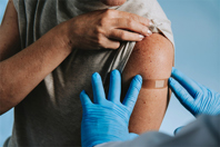 GettyImages-2237603339-arm-with-bandaid-doctor