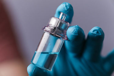 GettyImages-1439394099-vial-aspetic-filling-glove