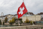 Swiss flag over the river Rhine in Basel-GettyImages-1077271520