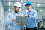 GettyImages-899692706 Project Manager And Chief Engineer Using Laptop In Modern Factory