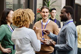 Business professionals chatting at conference-GettyImages-1385328437