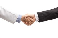 Doctor and businessman shaking hands-GettyImages-2152692597