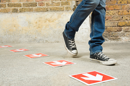 person walking by arrows-GettyImages-92347833